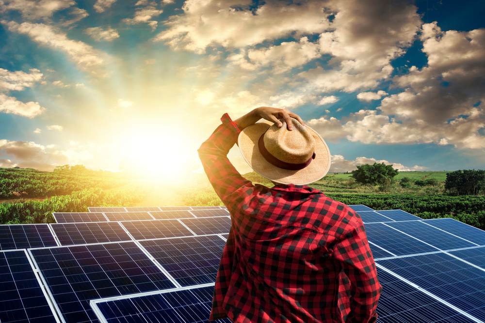 Homem com chapéu e placas solares na frente